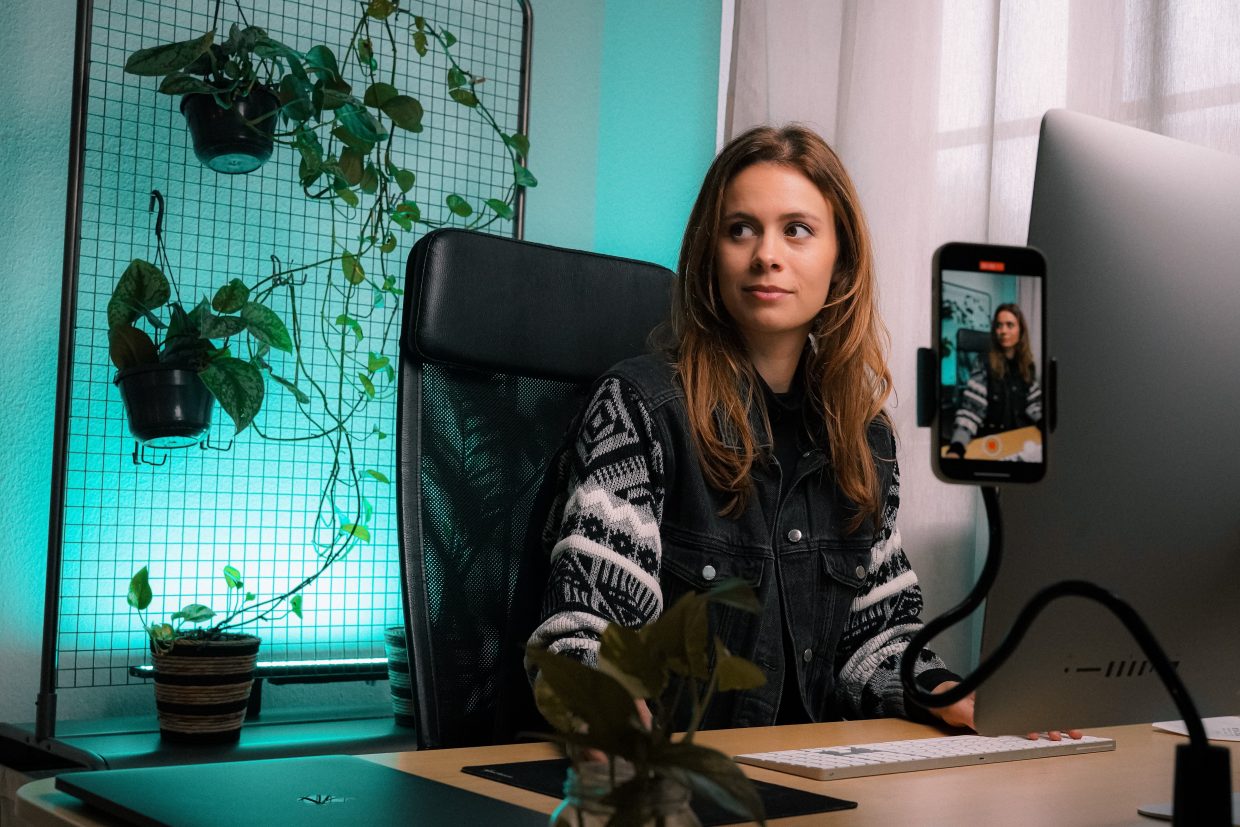 A woman in front of a filming set up.