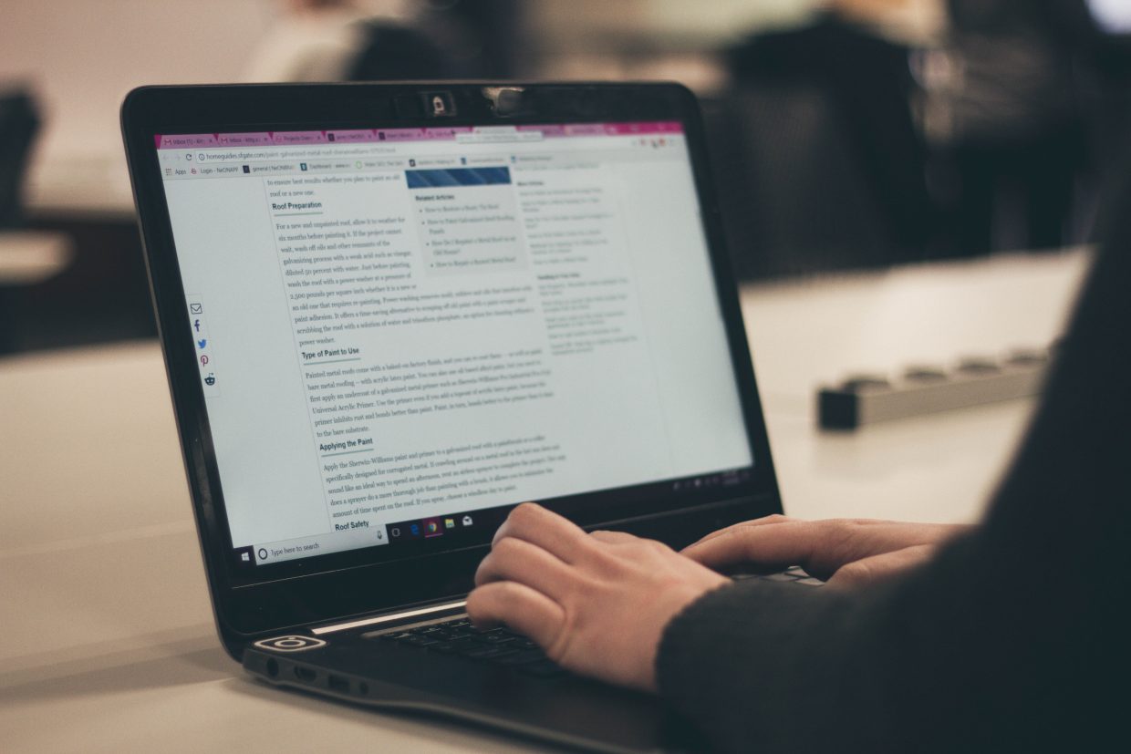 Hands typing at a computer.