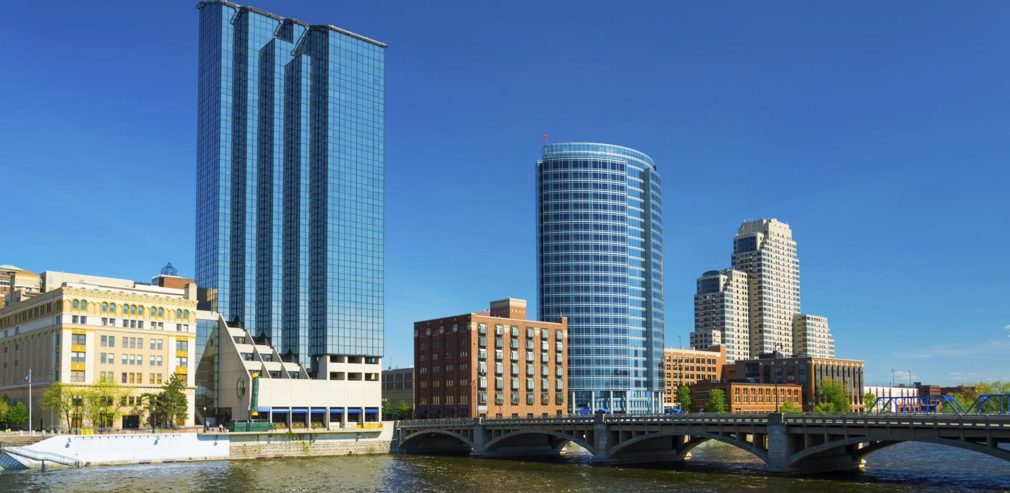 Grand Rapids downtown skyline with Grand River in the foreground.